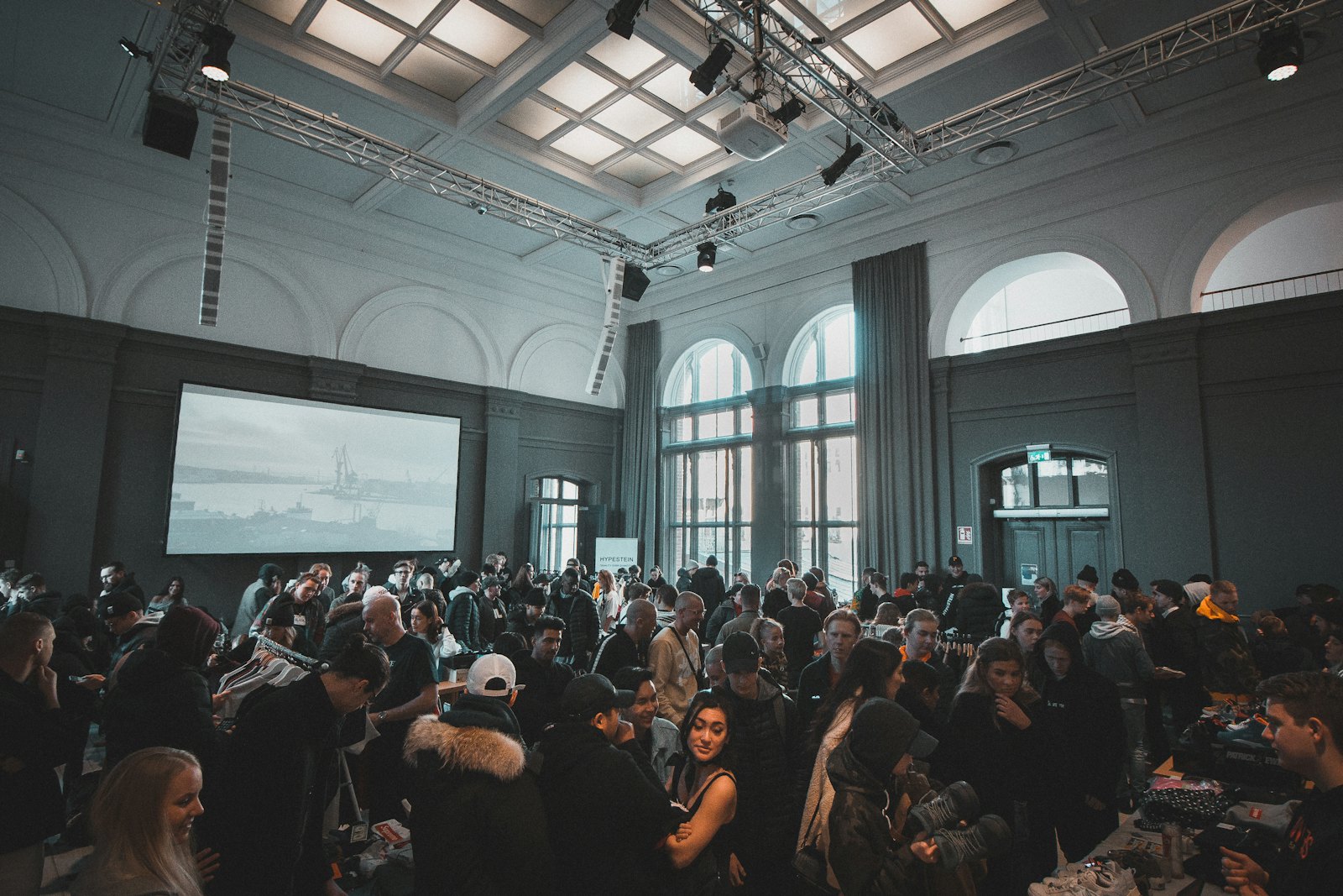 A full hall of attendees watching a presentation