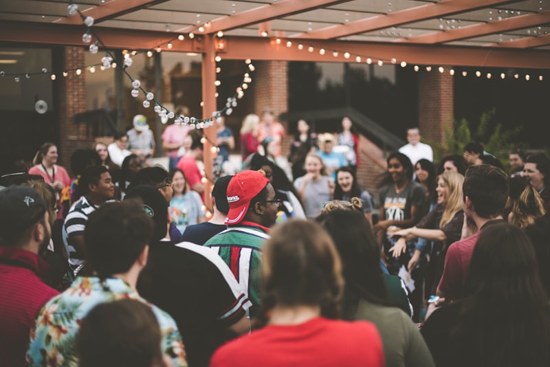 Attendees gathered under string lights at an outdoor event