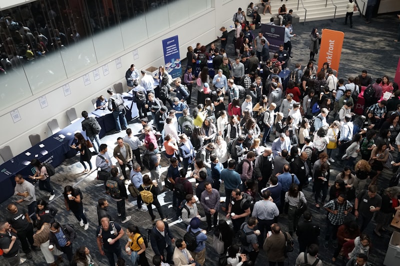 A crowd arriving through a venue foyer, seen from above