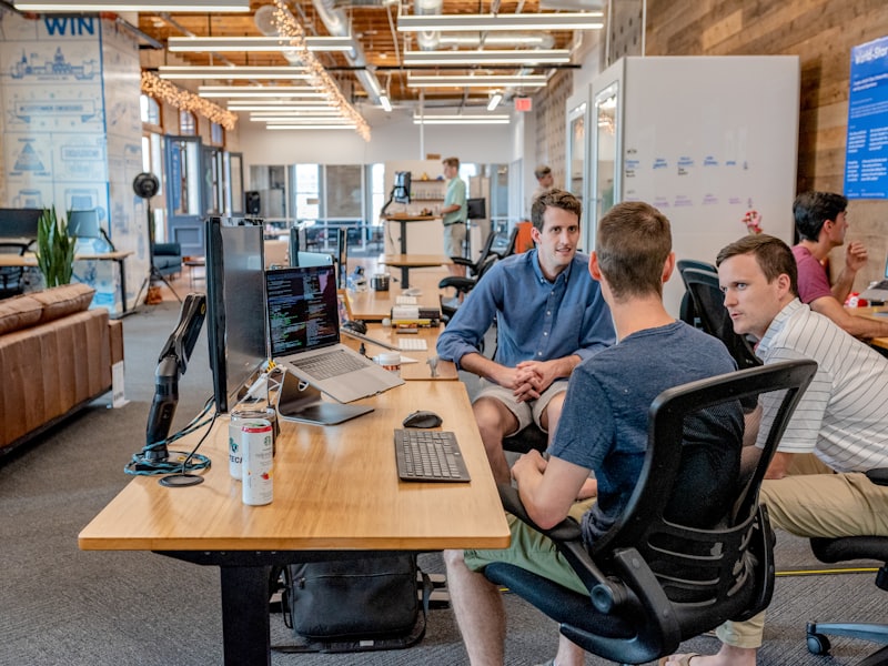 An operations team working together at a desk of monitors